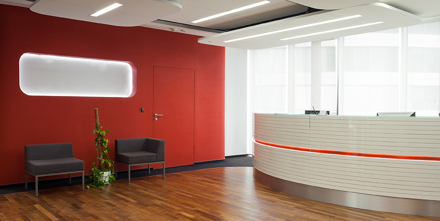Office reception before vinyl wrapping — dark red wall, outdated look